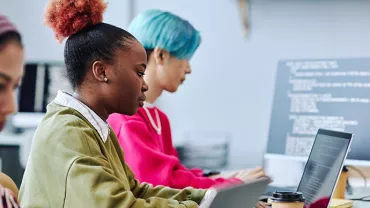 Persone che lavorano al computer in un ufficio moderno.